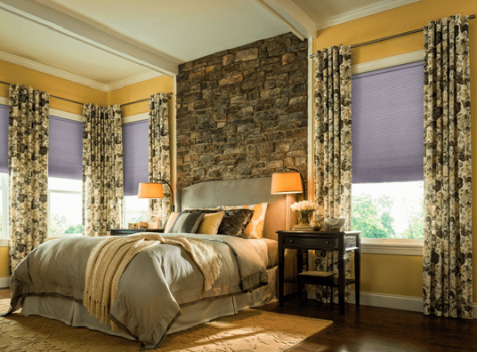 The interior of a Kansas City home's bedroom, featuring custom fabric window treatments by The Blind Broker.