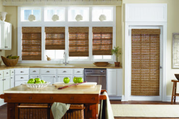Wooden woven shades in a home's kitchen, lending to the natural theme extended through the furniture. Available at The Blind Broker.