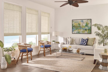 Graber natural wooden woven shades in a home's living space, filtering natural light. Available at The Blind Broker of Kansas City.