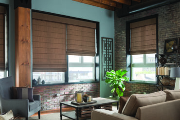 Roman shades in a modern industrial living space. Available at The Blind Broker of Kansas City.
