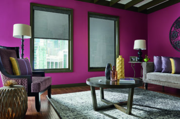 Graber solar shades in grey, featured in a contemporary red living space. Available at The Blind Broker of Kansas City.