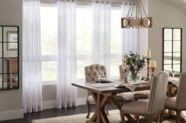 Graber drapery in a home dining room, showcasing sheer, textured drapes. Available at The Blind Broker of Kansas City.