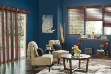 Naturally-finished wooden blinds in a home rec room, complimenting the wooden floors. Available at The Blind Broker of Kansas City.