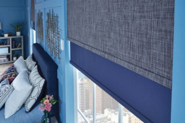 Custom motorized blinds by The Blind Broker in a contemporary Kansas City bedroom, featuring two layers of varying fabric colors and textures.