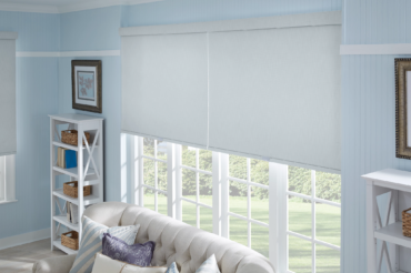 A set of custom fabric shades in a bright Kansas City home's living space, by The Blind Broker.