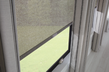 Custom sheer fabric blinds by The Blind Broker of Kansas City, featuring a natural tone and full pane coverage.