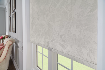Custom roller fabric shades by the Blind Broker of Kansas City, featuring textured floral design.