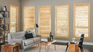 Natural wooden shutters in a home's living space, by The BlindBroker.