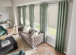 Patterned, sage green drapery in a mid-century living space, by The BlindBroker.
