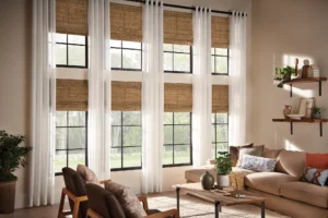 Natural, woven-texture shades over 2-story windows in a Kansas City home, by The BlindBroker.