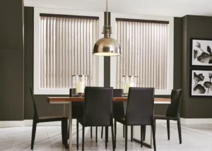Graber vinyl vertical blinds in a contemporary dining room table, offered by The BlindBroker.