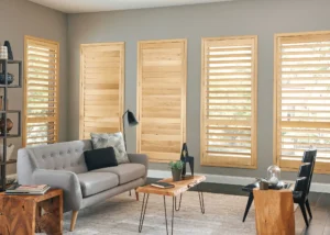 Natural wooden shutters in a home's living space, by The BlindBroker.
