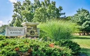 The city of Shawnee, KS, city limits signage with landscaping.