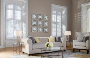 White plantation shutters in a lofty, naturally-lit Kansas City home living area.